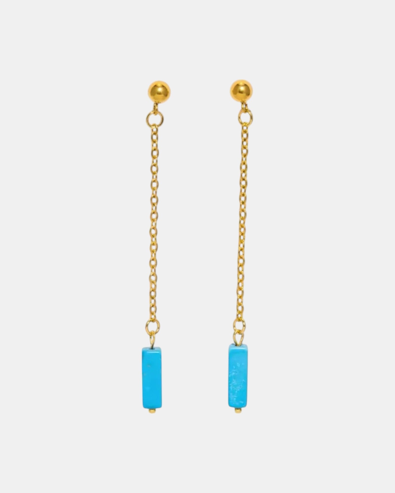 Gold dangle earrings with a blue stone