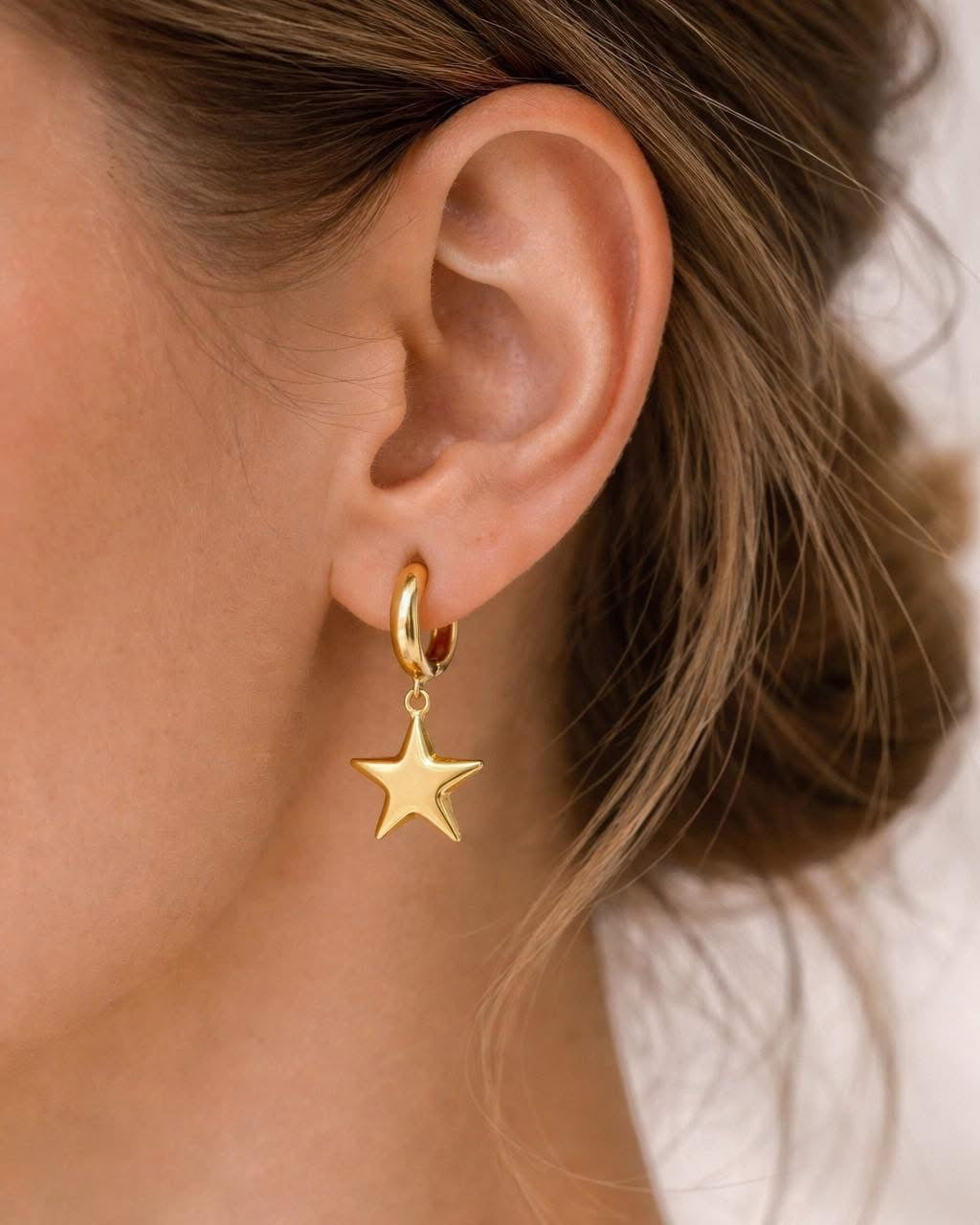 Gold dangle earrings with star design elegant jewelry accessory