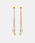 Gold dangling earrings with pearl.