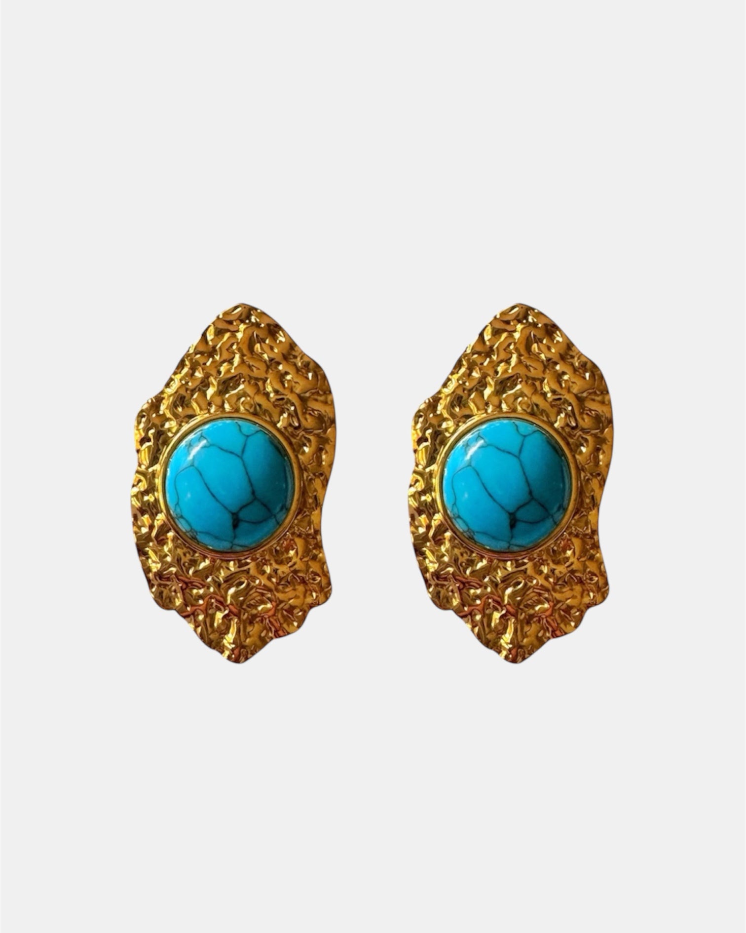 Gold dangling earrings with teal stone.