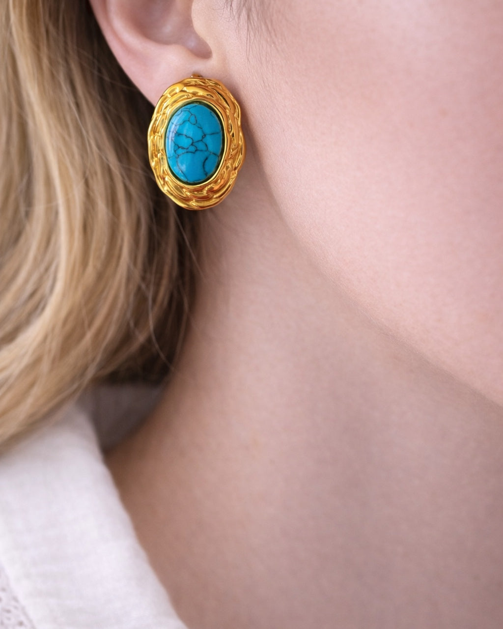 Gold earrings with turquoise stone.