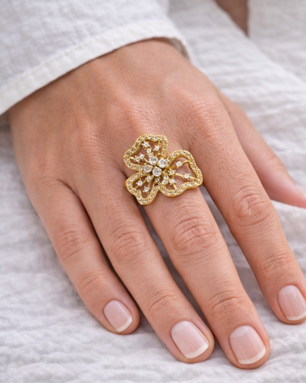 Gold flower ring with white zircon stones, elegant and feminine jewelry