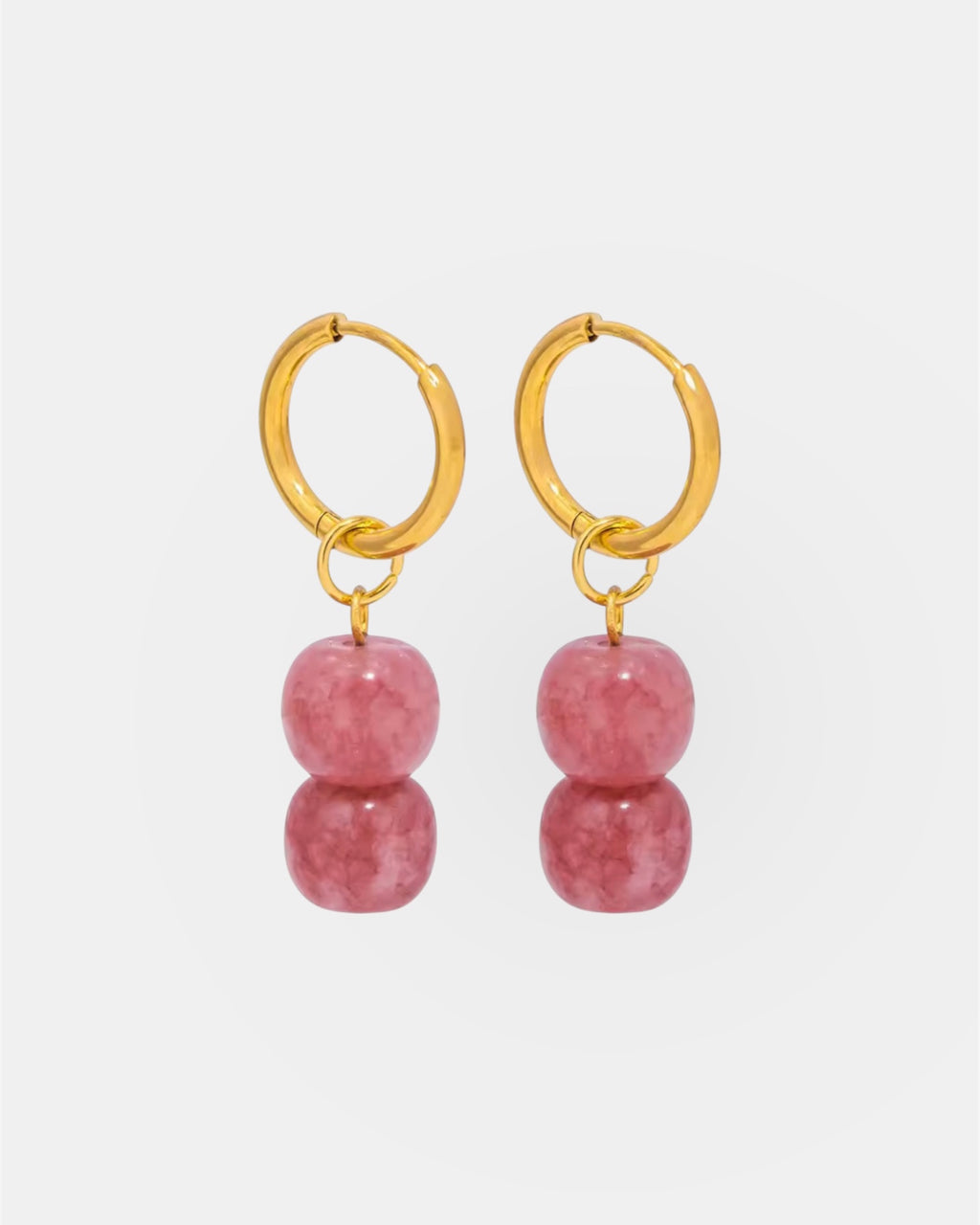 Gold hoop earrings with pink stones.