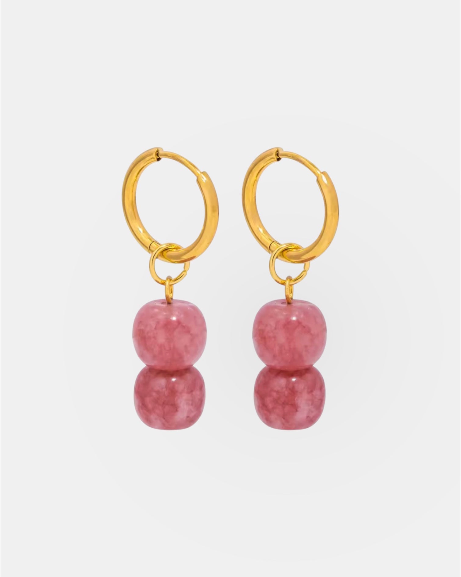 Gold hoop earrings with pink stones.