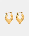Gold hoop earrings with twisted heart design.