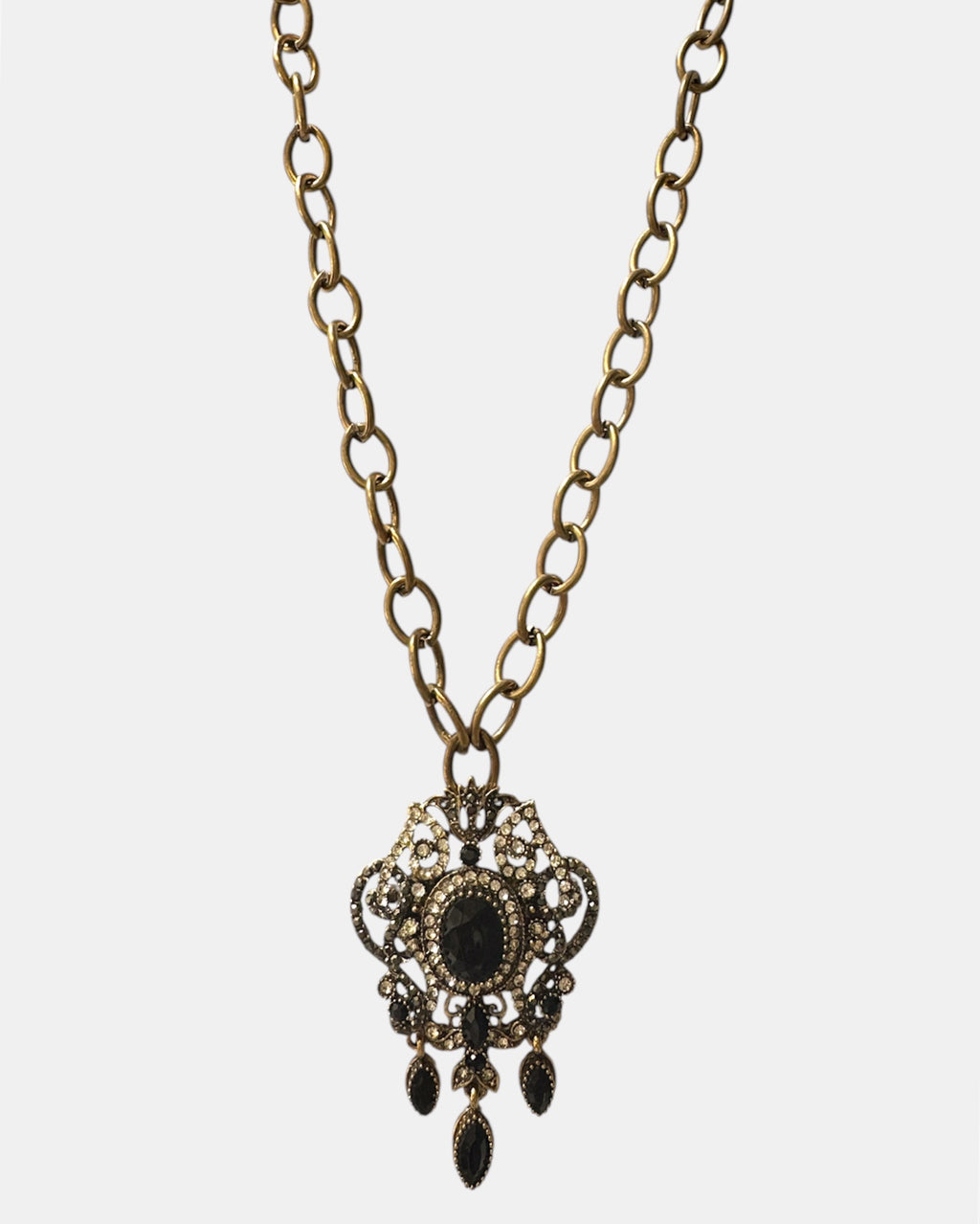 Gold necklace with a black vintage pendant
