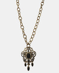 Gold necklace with a black vintage pendant