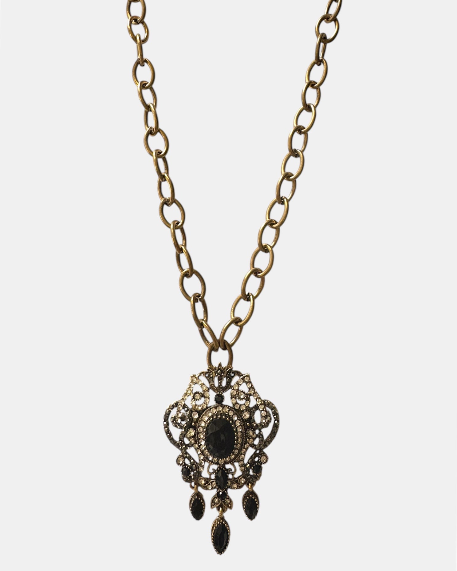 Gold necklace with a black vintage pendant