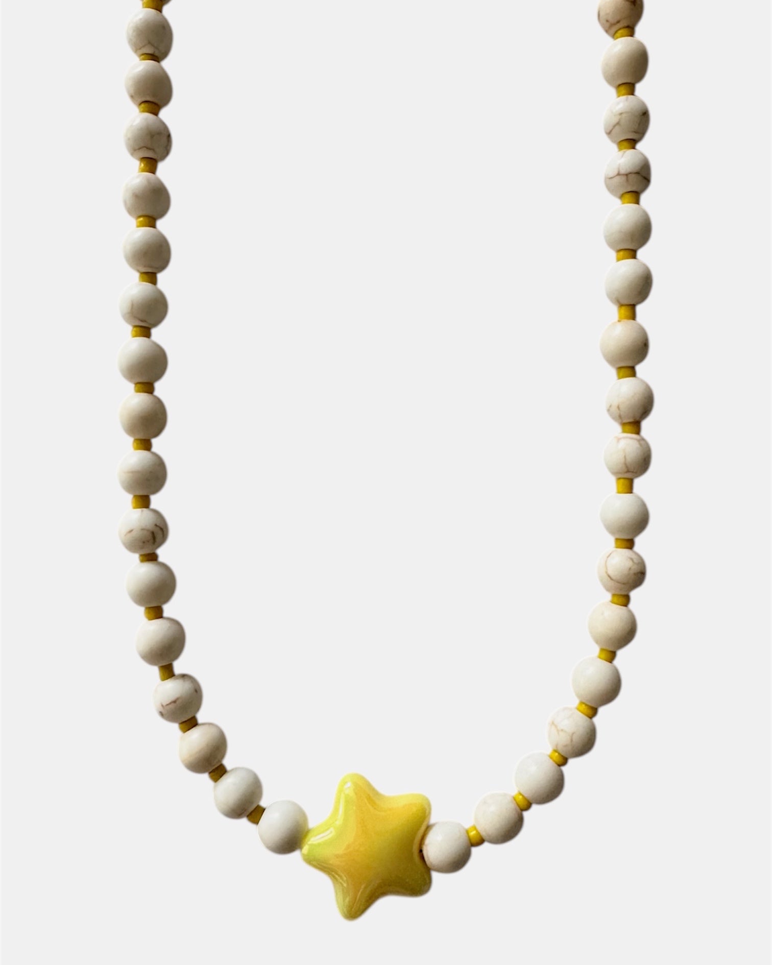 gold necklace with ecru beads and yellow ceramic star charm, elegant jewelry piece for women and girls