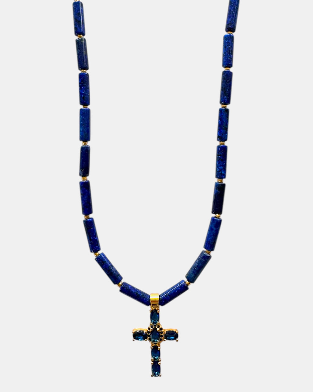 Necklace with blue beads and a cross pendant on a white background