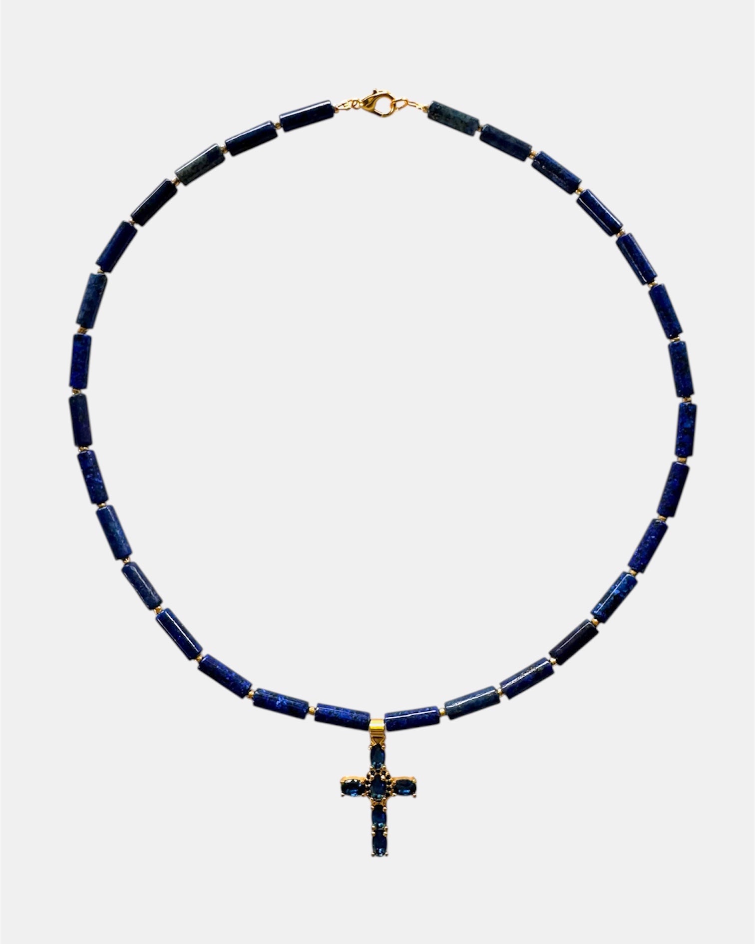 Necklace with blue beads and a cross pendant on a white background