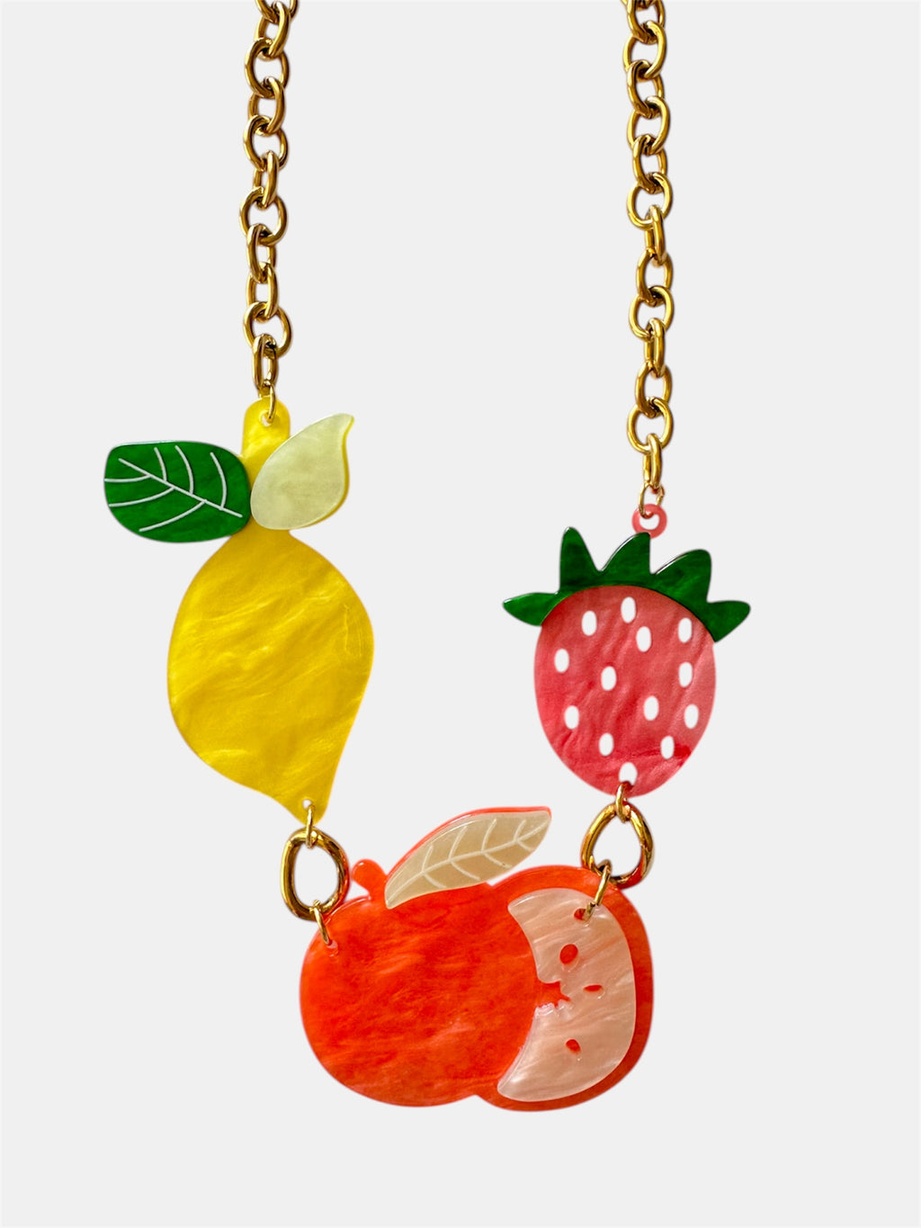 Gold necklace featuring small fruit-shaped charms for a playful and stylish look