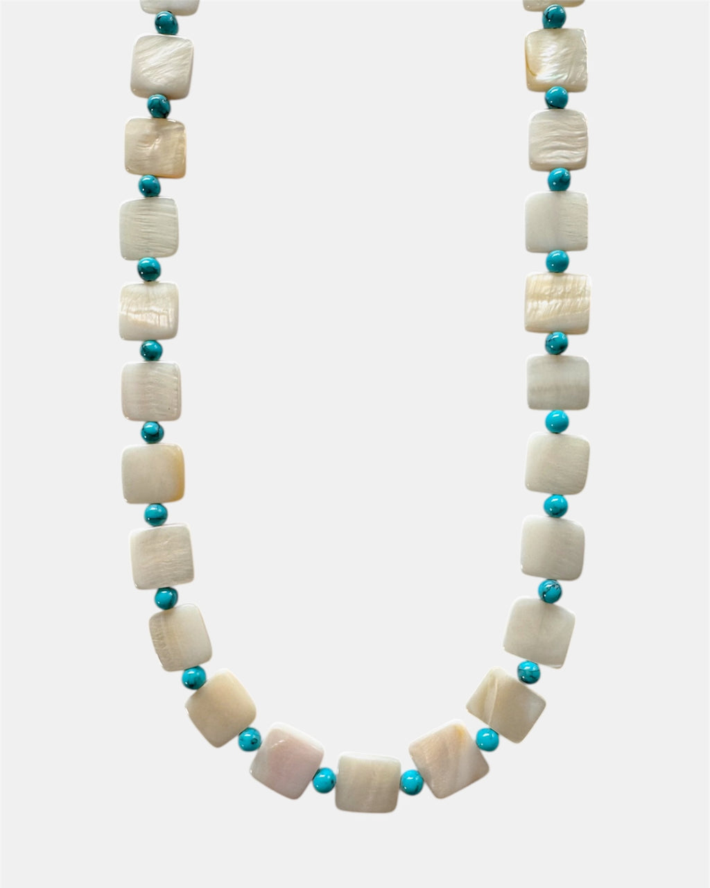 Necklace with white shell beads and turquoise beads on a white background