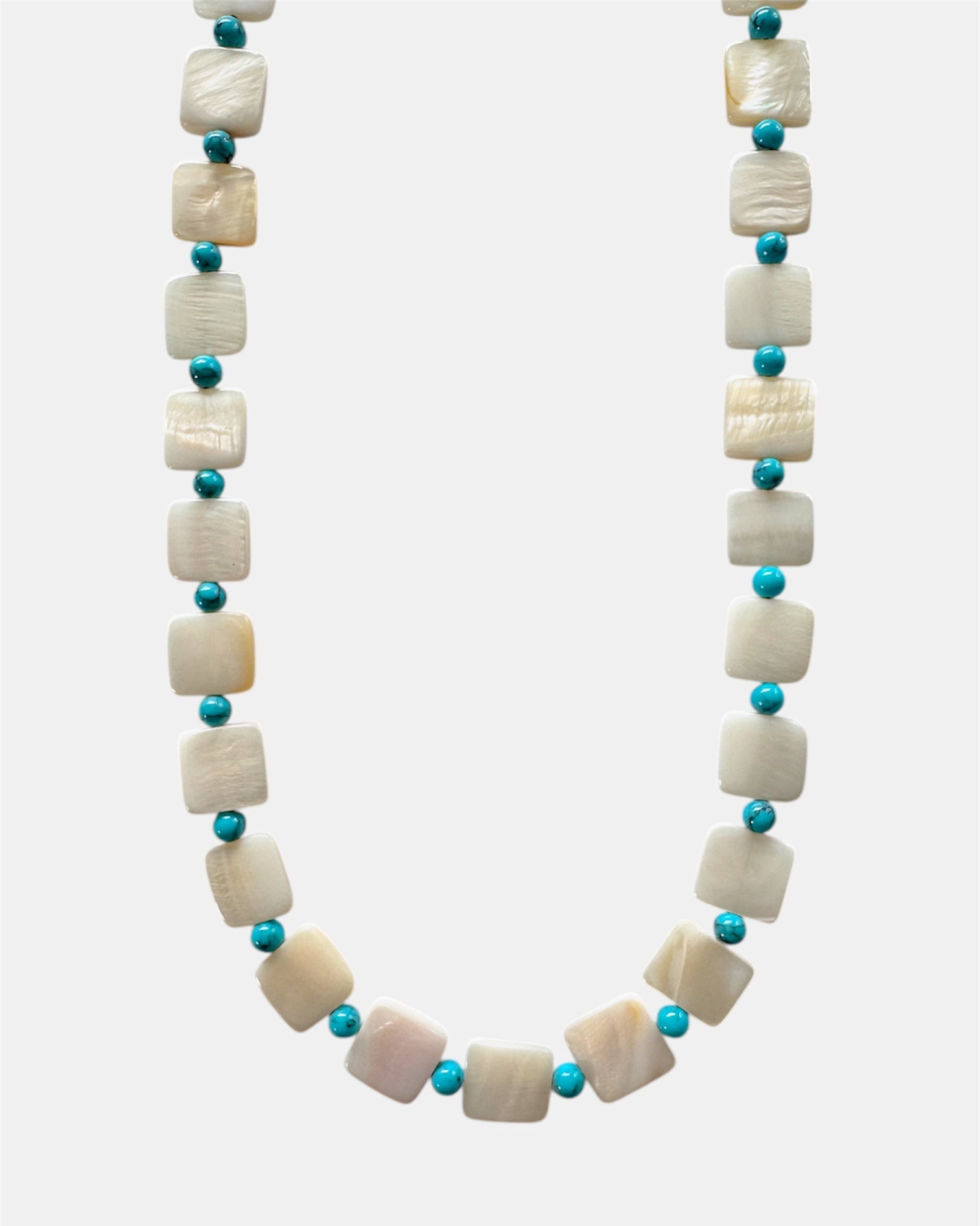 Necklace with white shell beads and turquoise beads on a white background