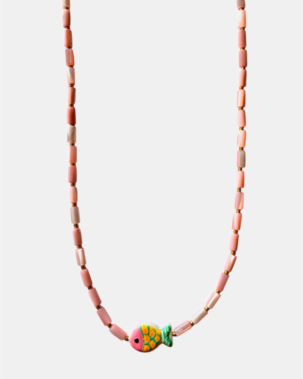 Necklace with pink beads and a colorful fish charm on a white background