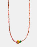 Necklace with pink beads and a colorful fish charm on a white background