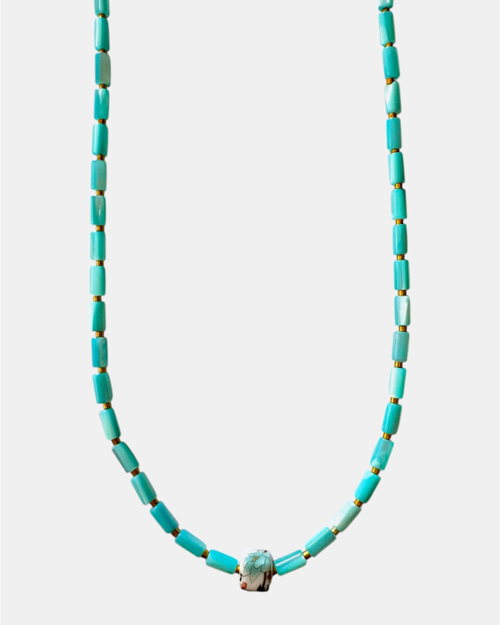 Turquoise beaded necklace on a white background