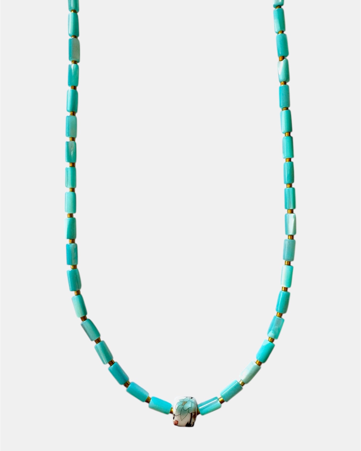 Turquoise beaded necklace on a white background