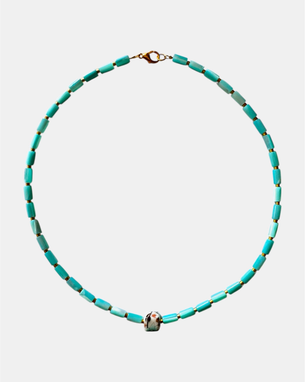 Turquoise beaded necklace on a white background