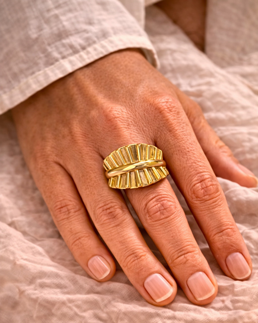 Gold ring with textured surface, elegant modern jewelry piece