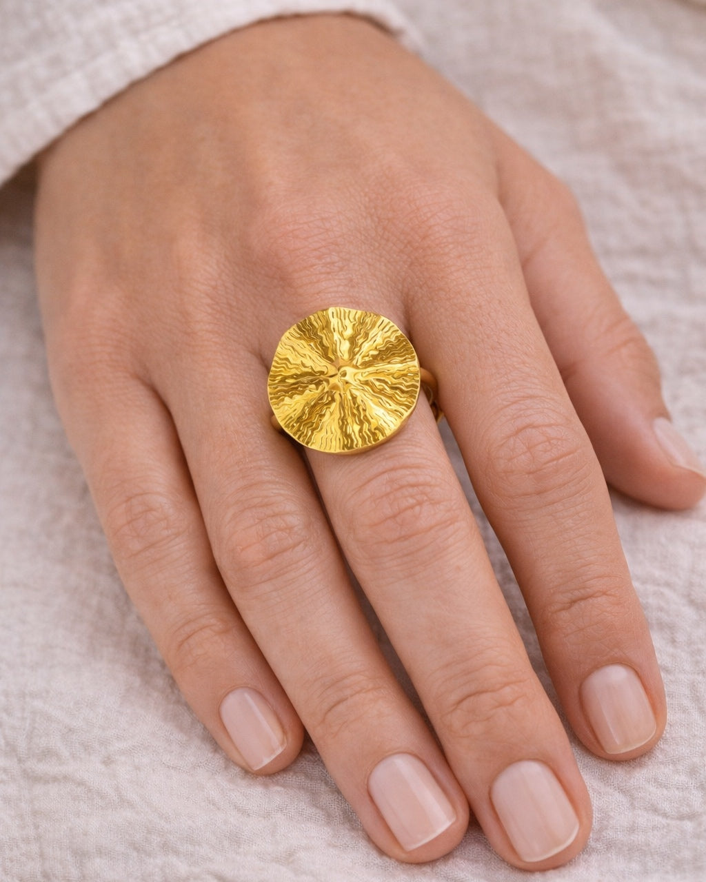 Gold ring with textured surface design
