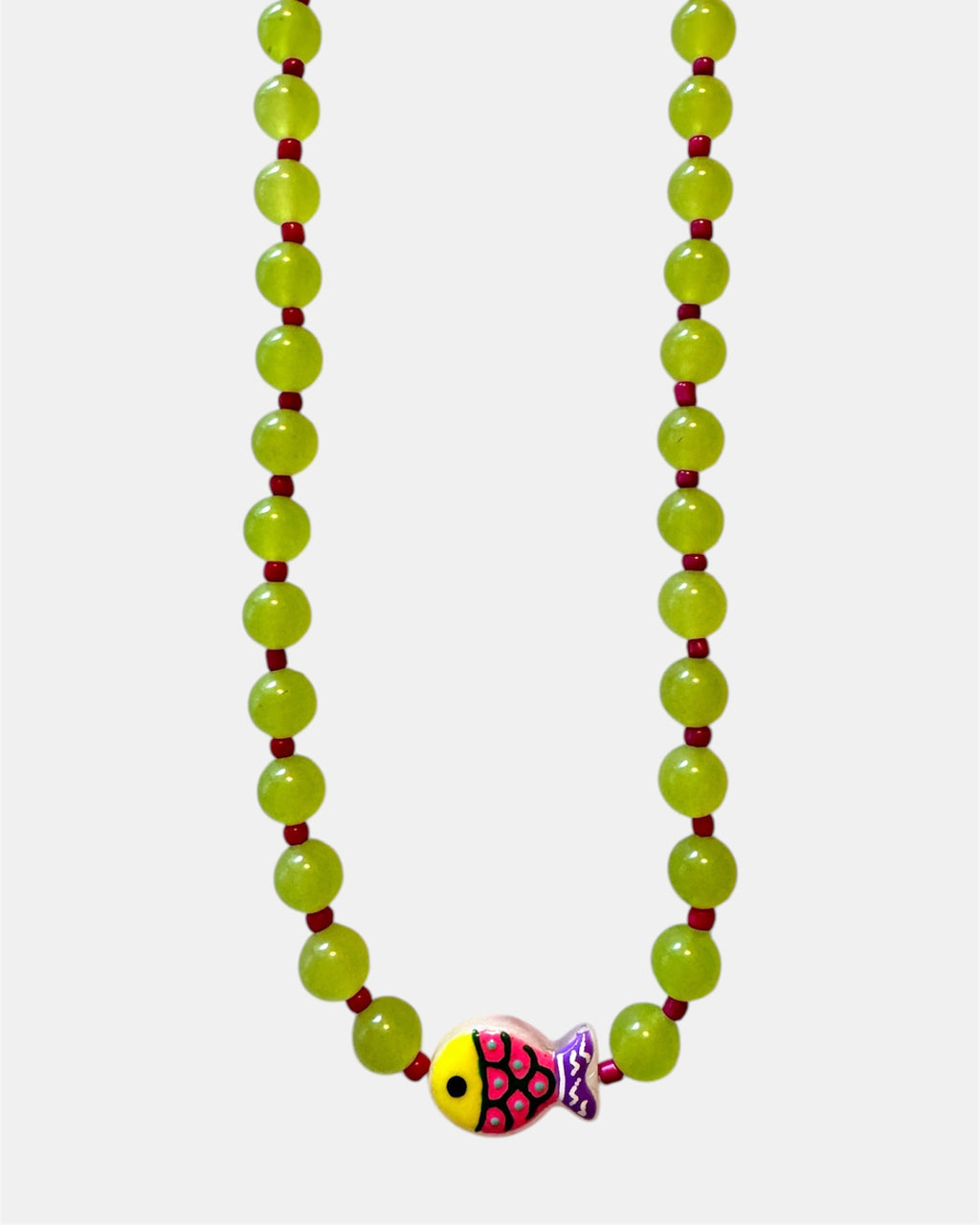 Green beaded necklace featuring a small fish charm for a playful and ocean-inspired style