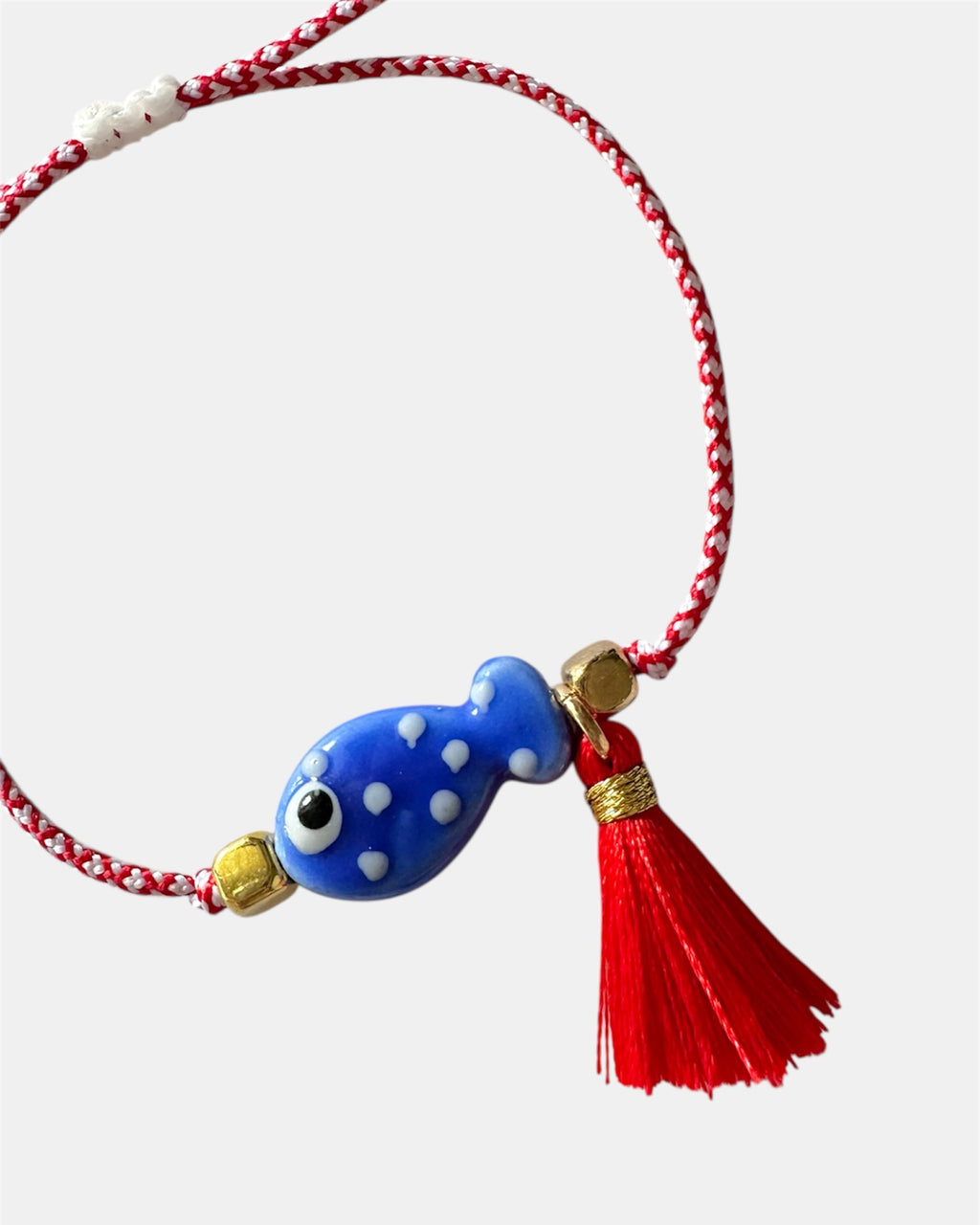 Χειροποίητο μαρτάκι με μπλε γυάλινο ψαράκι και κόκκινη φούντα σε κόκκινο-λευκό κορδόνι