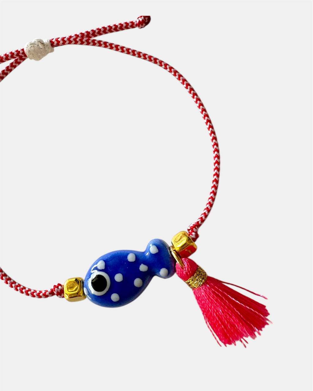 Χειροποίητο μαρτάκι με μπλε γυάλινο μάτι, κόκκινη φούντα και κόκκινο-λευκό κορδόνι