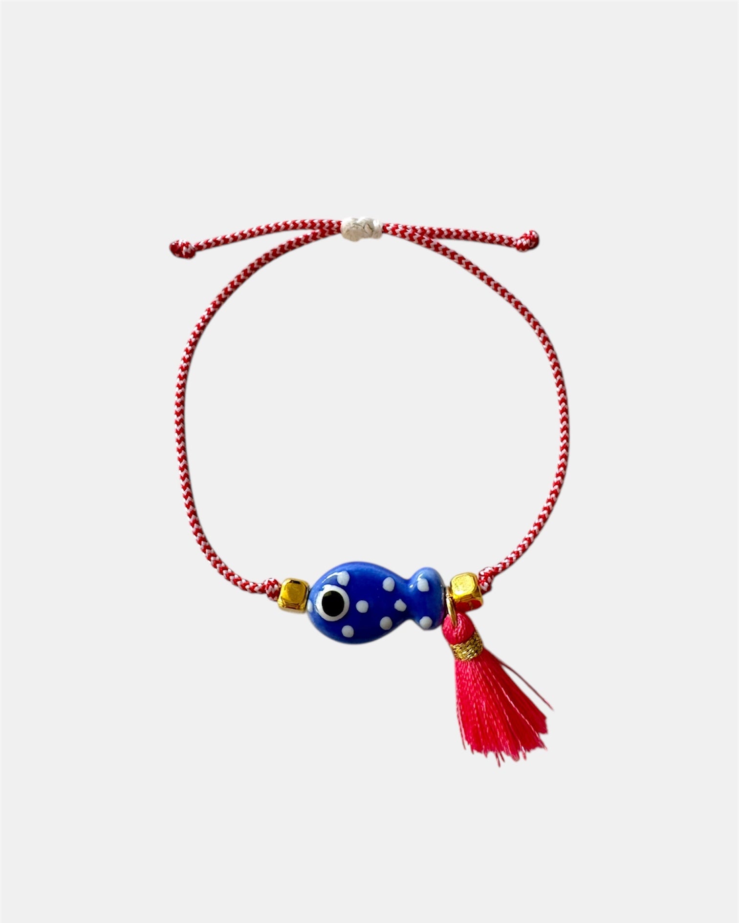 Χειροποίητο μαρτάκι με μπλε γυάλινο μάτι, κόκκινη φούντα και κόκκινο-λευκό κορδόνι