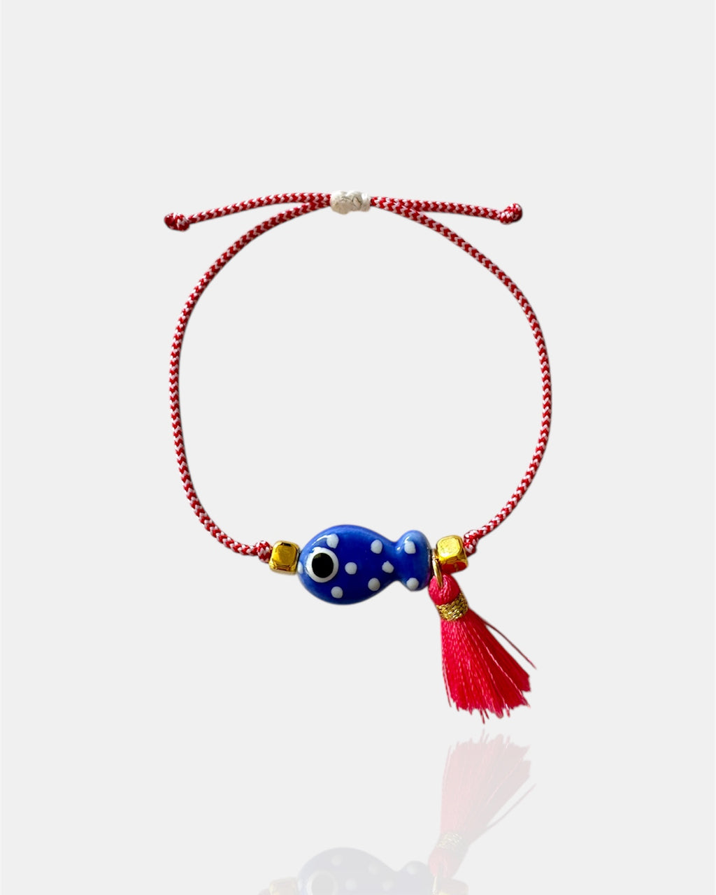 Χειροποίητο μαρτάκι με μπλε γυάλινο μάτι, κόκκινη φούντα και κόκκινο-λευκό κορδόνι