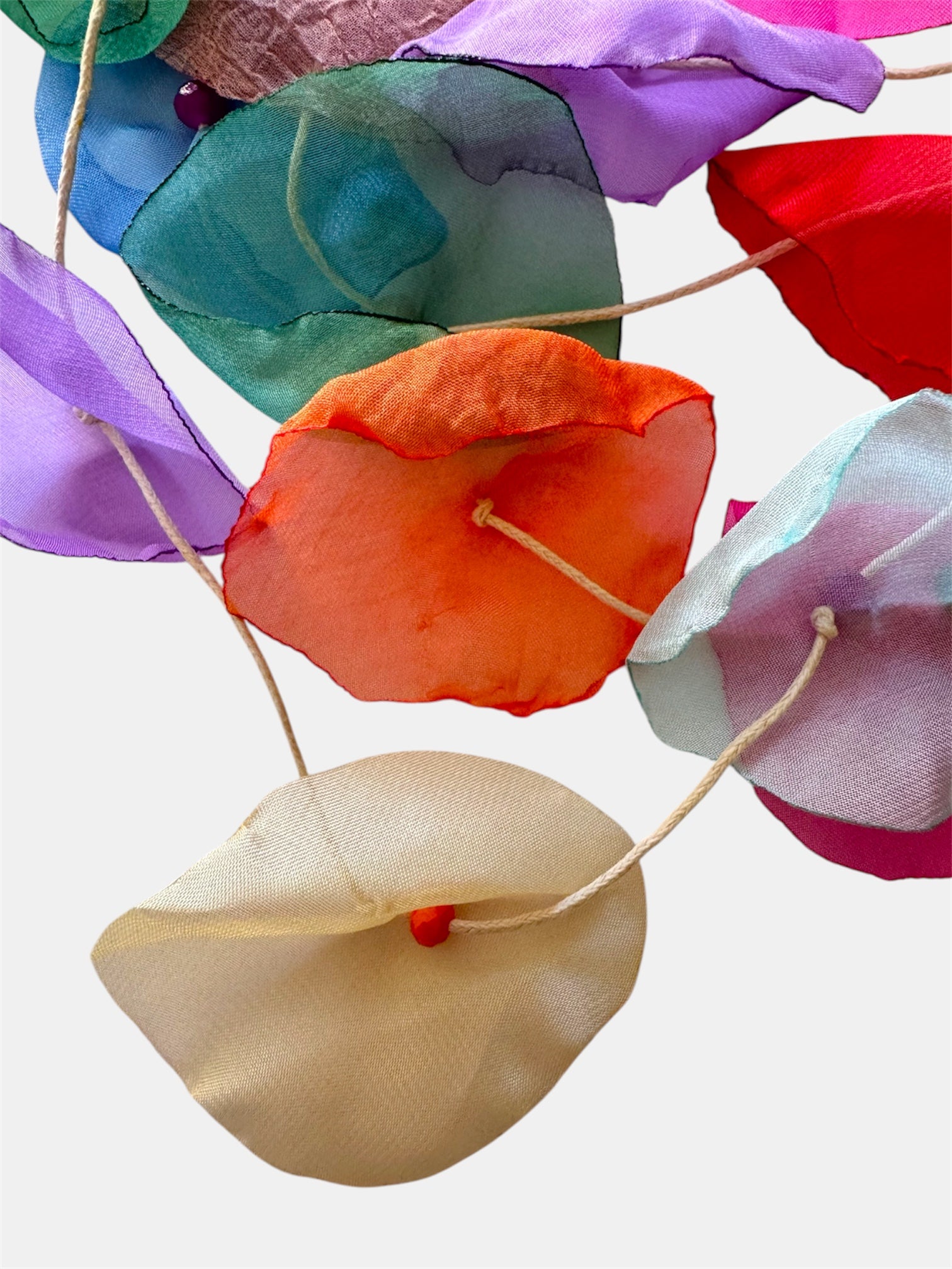 Multicolored necklace adorned with fabric flowers for a vibrant and whimsical style