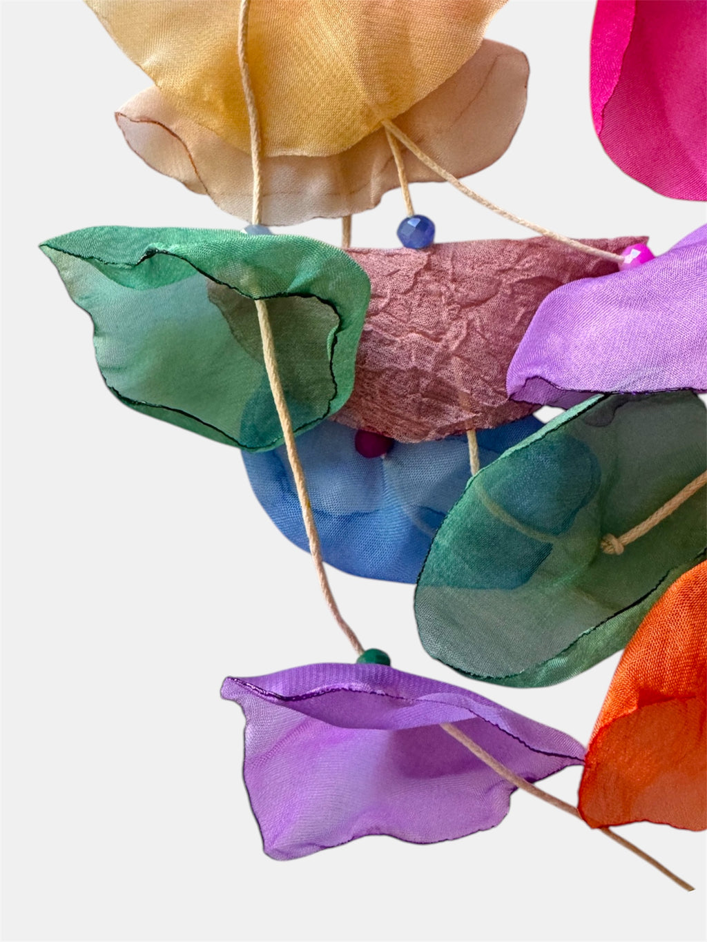 Multicolored necklace adorned with fabric flowers for a vibrant and whimsical style