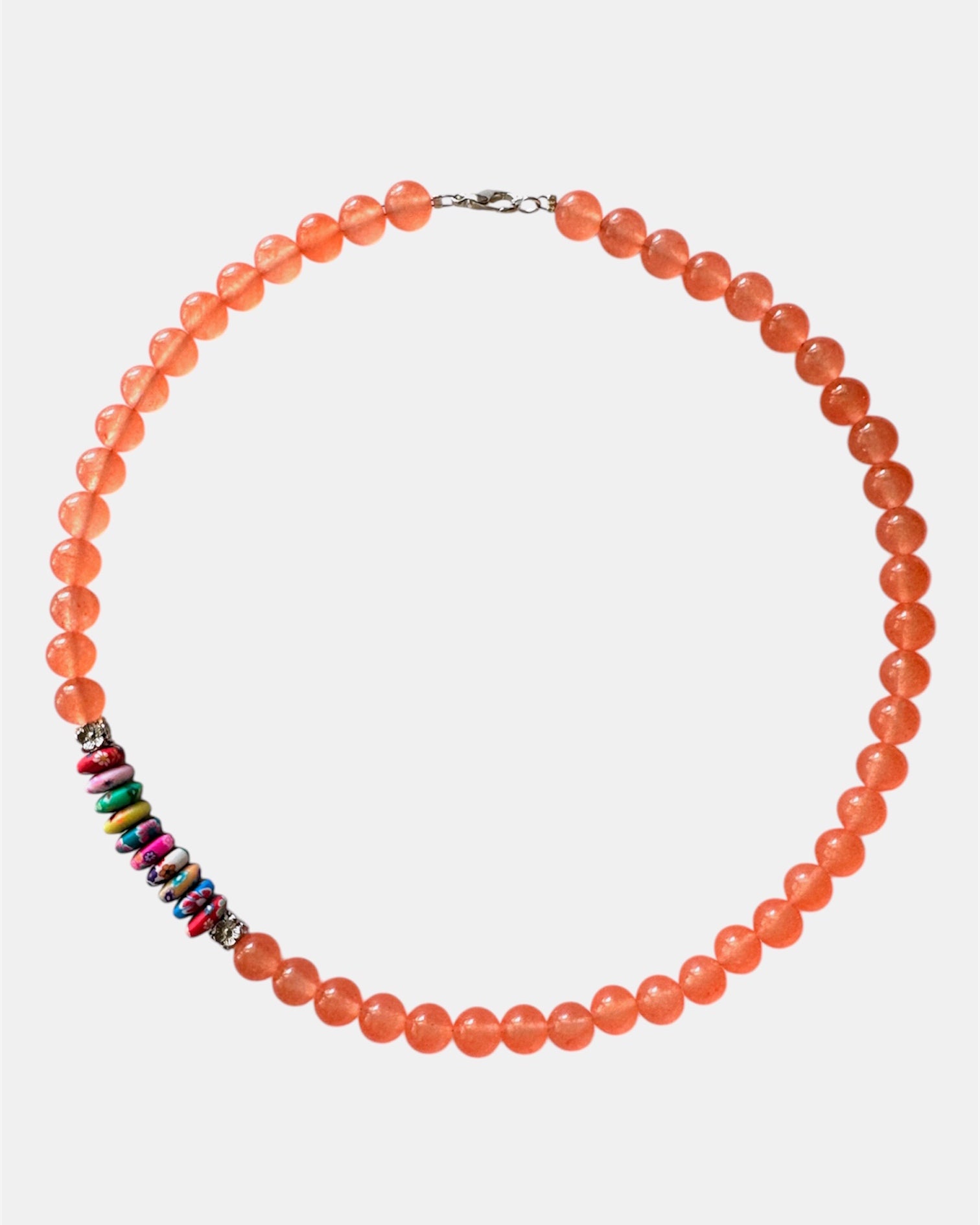 Vibrant orange necklace with beads and multicolor elements, handmade statement jewelry with a playful and colorful design