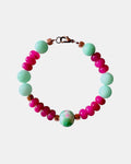 Pink and mint beaded bracelet featuring a ceramic charm for a playful and colorful style