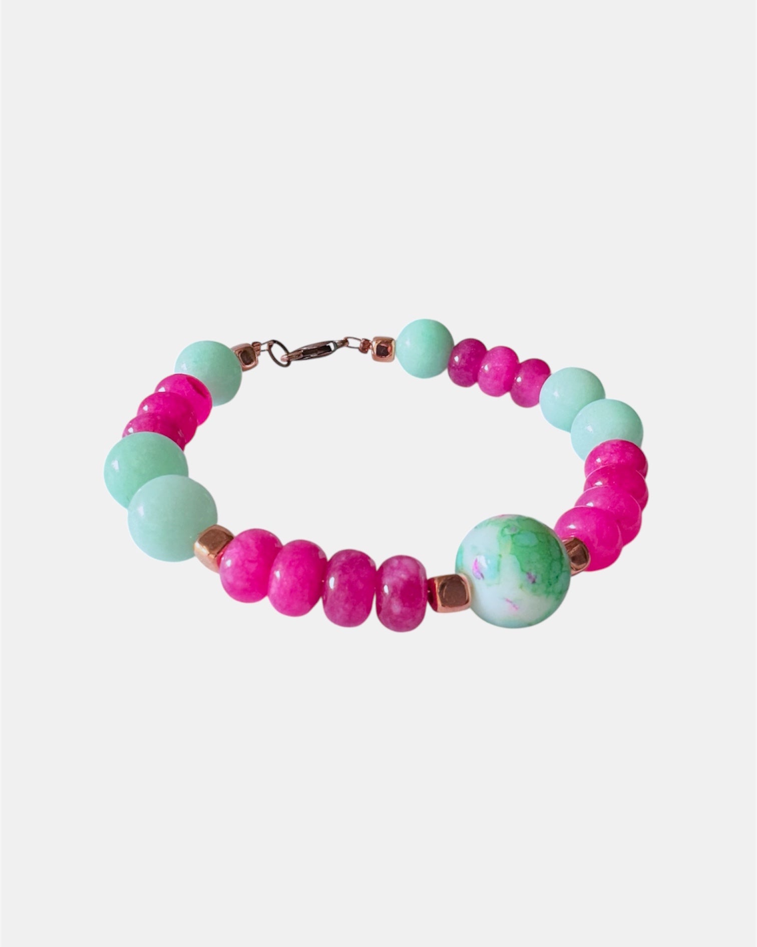 Pink and mint beaded bracelet featuring a ceramic charm for a playful and colorful style