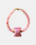 Pink beaded bracelet featuring a candy-shaped charm for a playful and sweet look