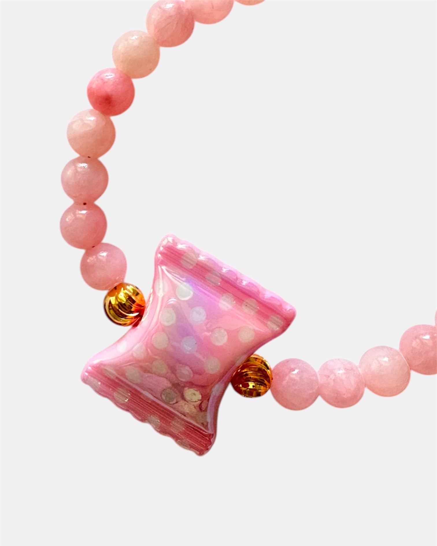Pink beaded bracelet featuring a candy-shaped charm for a playful and sweet look