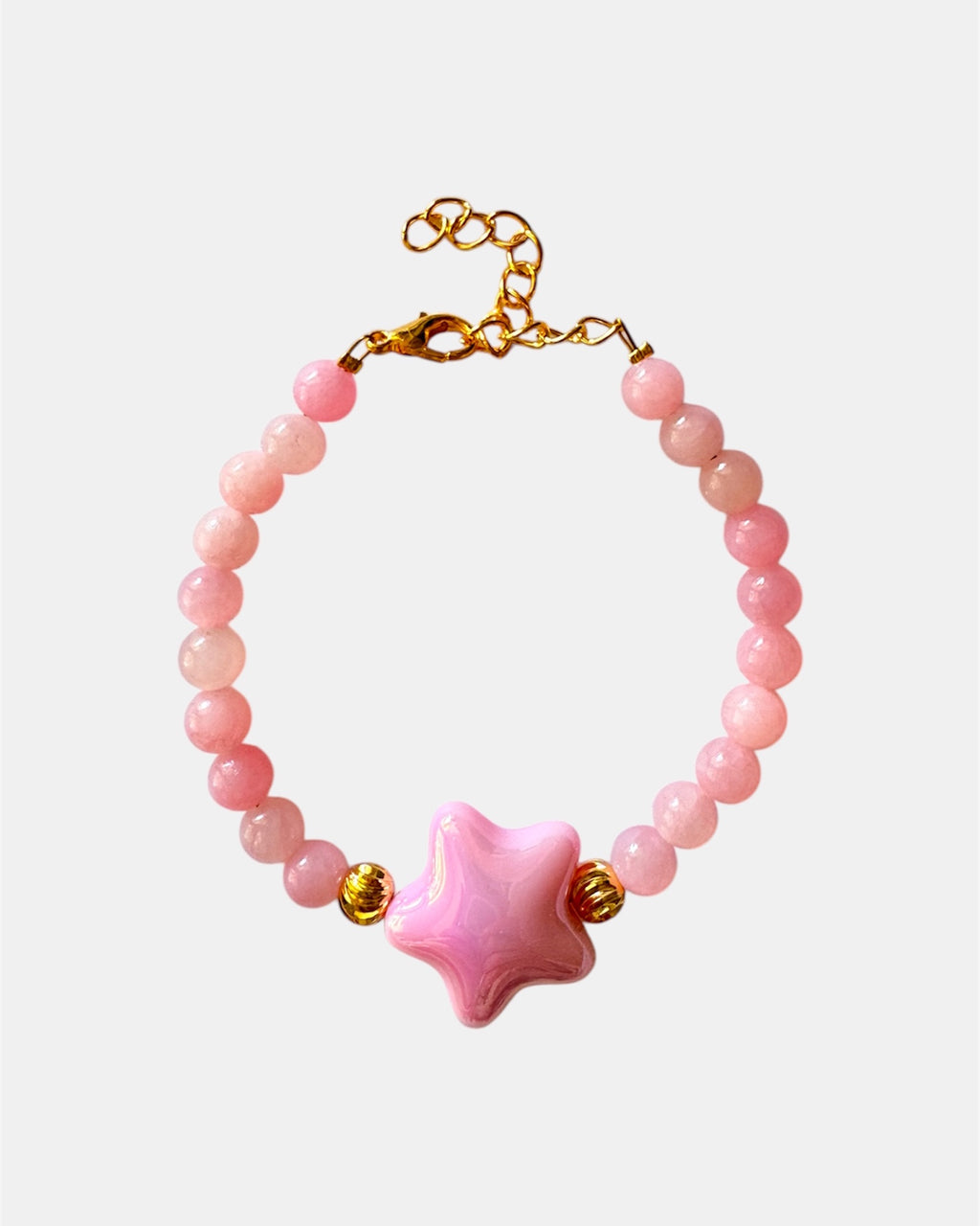 Pink beaded bracelet decorated with a small star charm for a cute and whimsical look