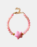 Pink beaded bracelet decorated with a small star charm for a cute and whimsical look