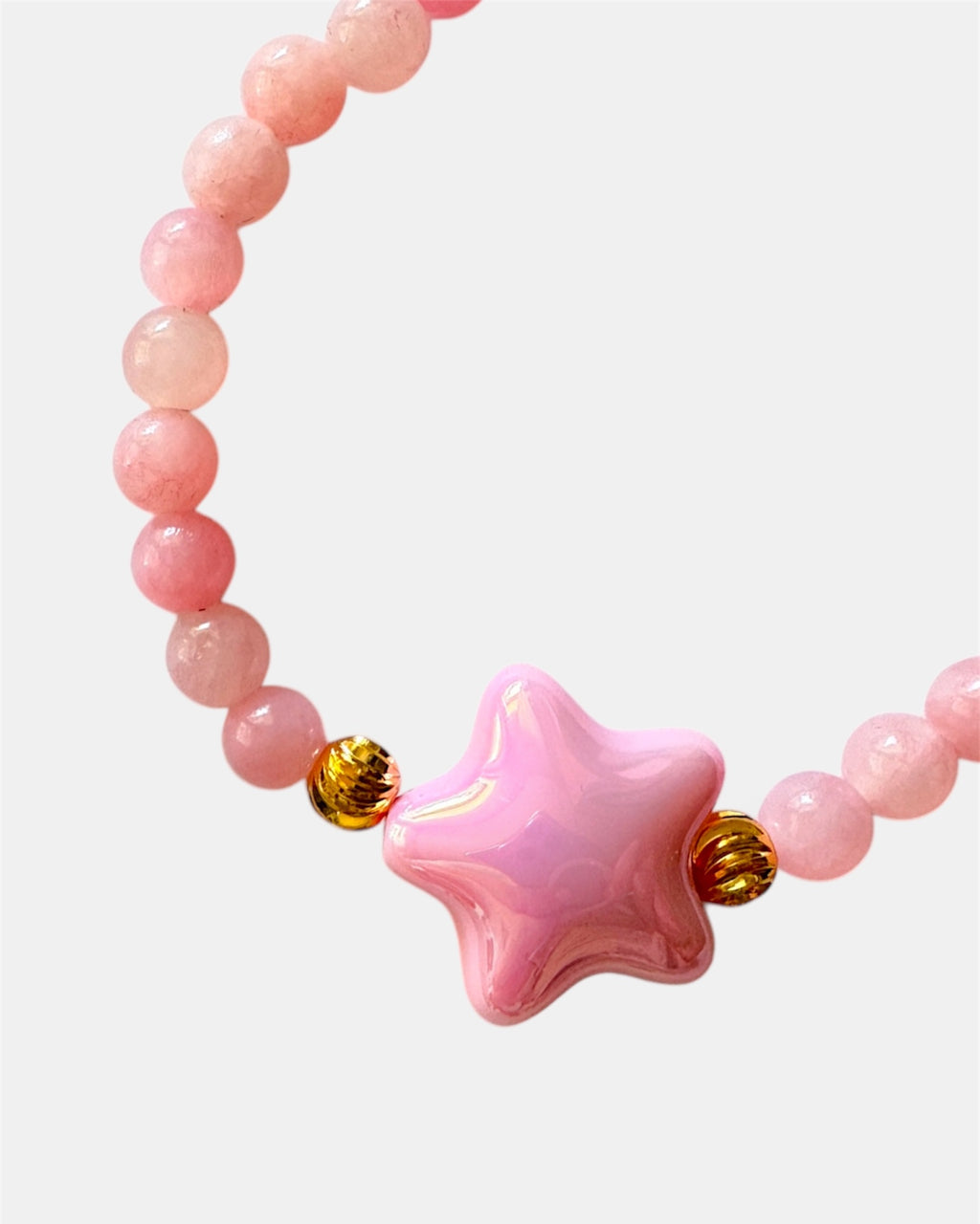 Pink beaded bracelet decorated with a small star charm for a cute and whimsical look