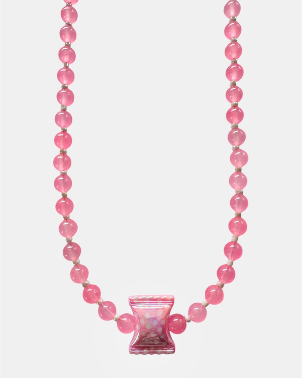 Pink beaded necklace with a pink glass charm on a white background