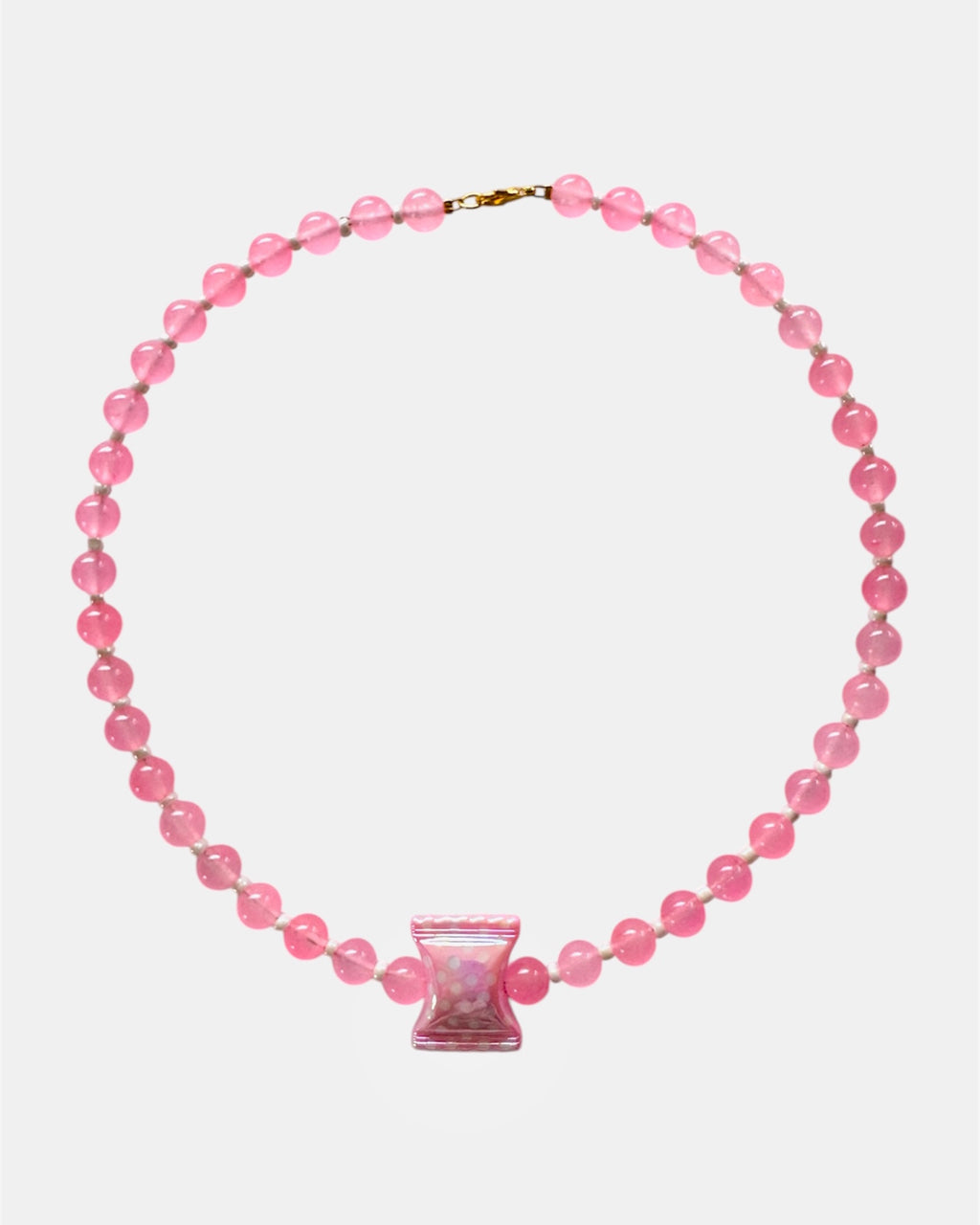 Pink beaded necklace with a pink clasp on a white background