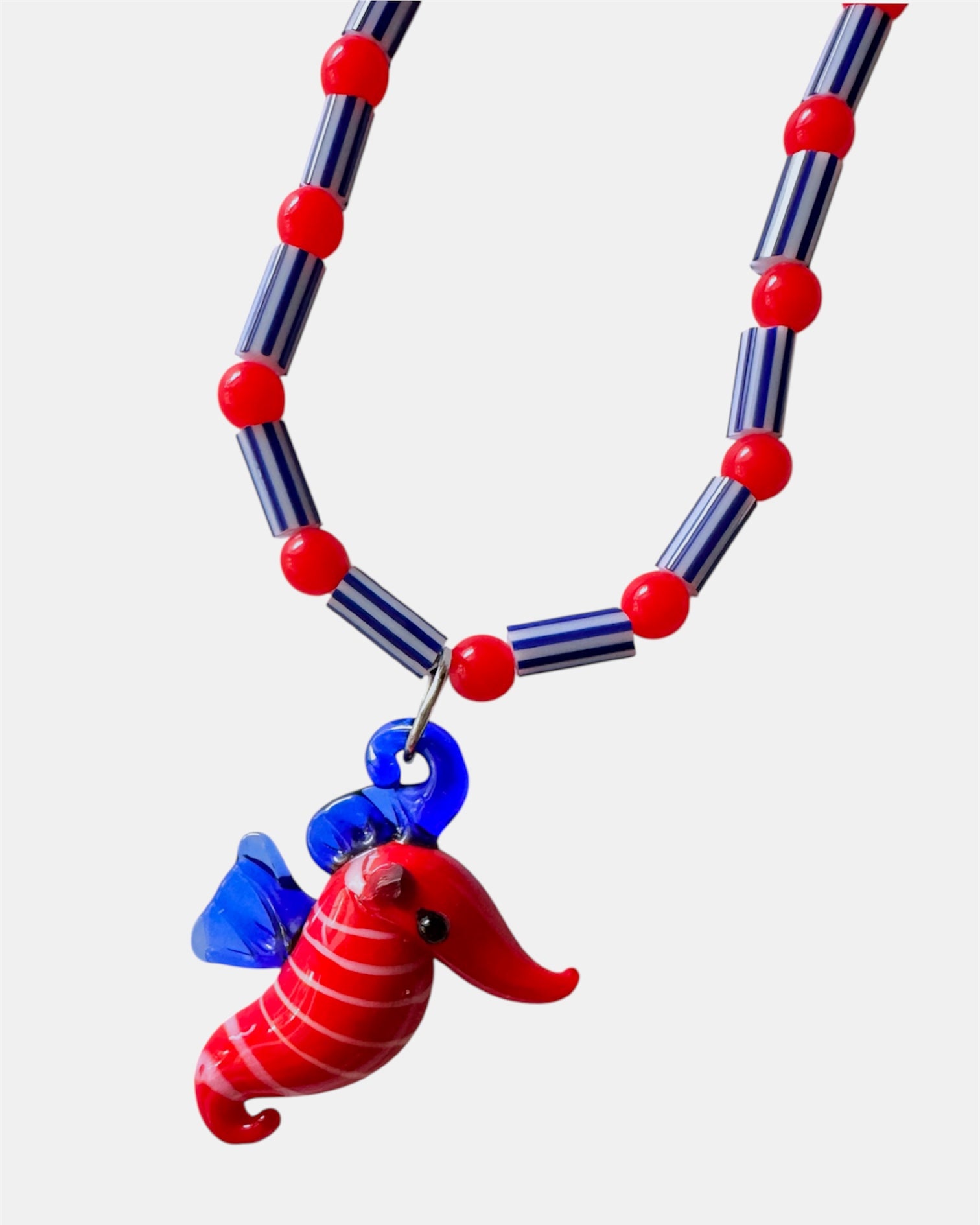 red and blue necklace with glass beads and seahorse charm, handmade jewelry piece for women and girls