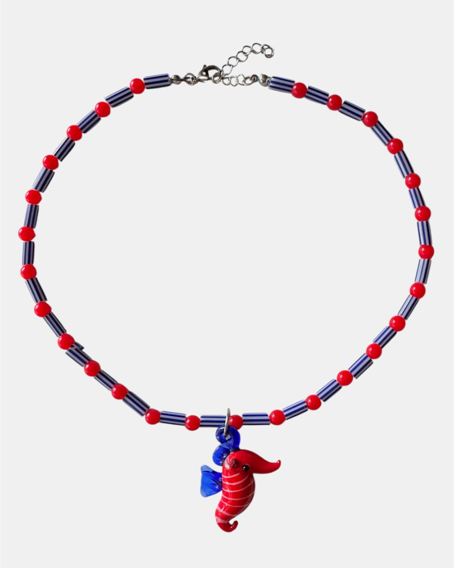 red and blue necklace with glass beads and seahorse charm, handmade jewelry piece for women and girls