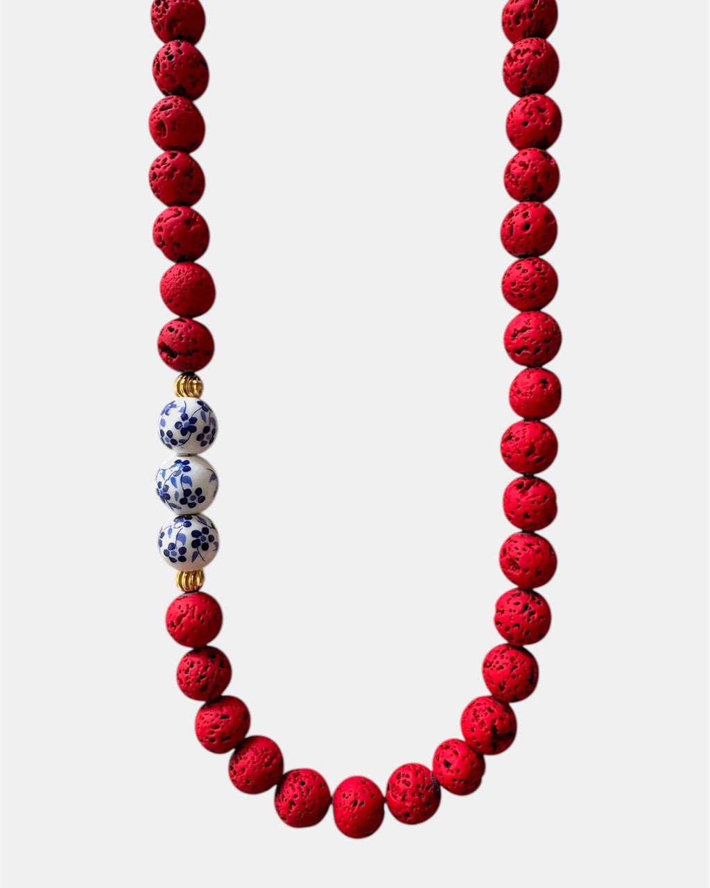 Bold red necklace with lava beads and porcelain elements, unique handmade jewelry with natural textures and modern design
