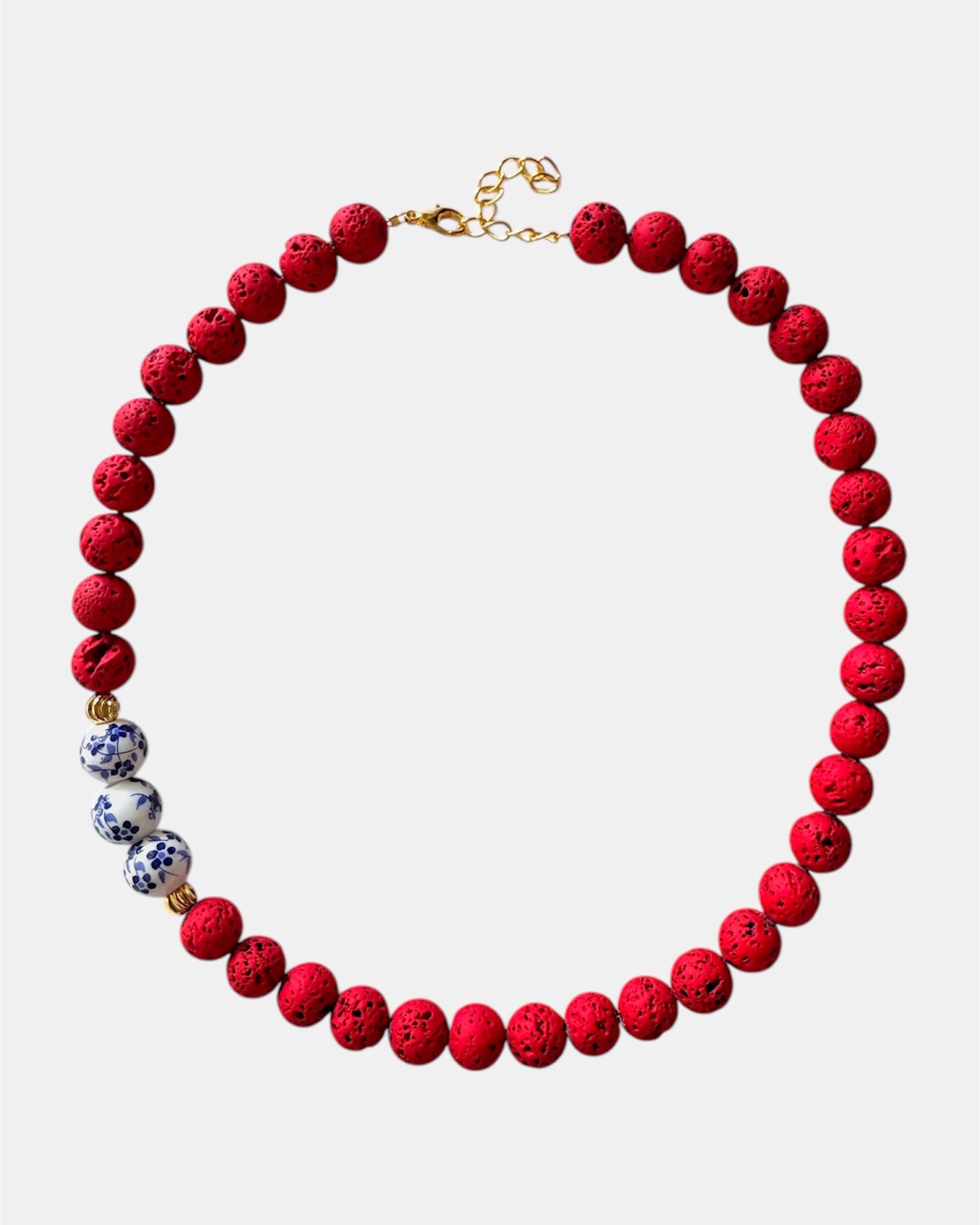 Bold red necklace with lava beads and porcelain elements, unique handmade jewelry with natural textures and modern design
