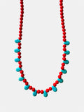 Red necklace featuring turquoise teardrop-shaped pendants for a vibrant and stylish look