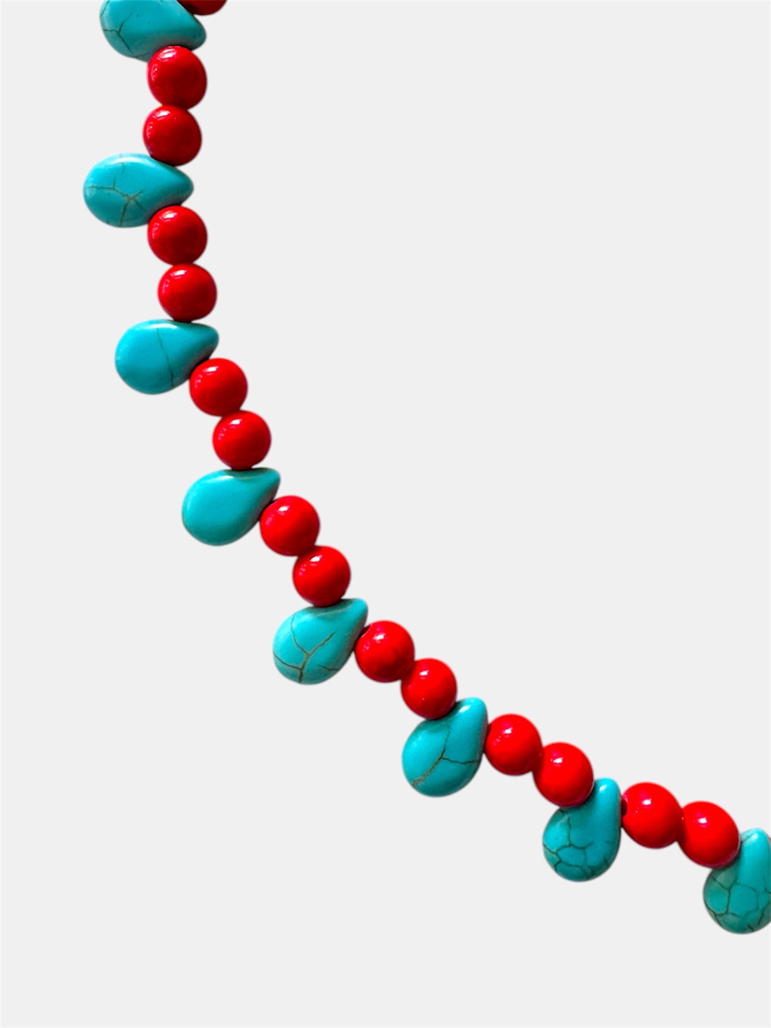 Red necklace featuring turquoise teardrop-shaped pendants for a vibrant and stylish look