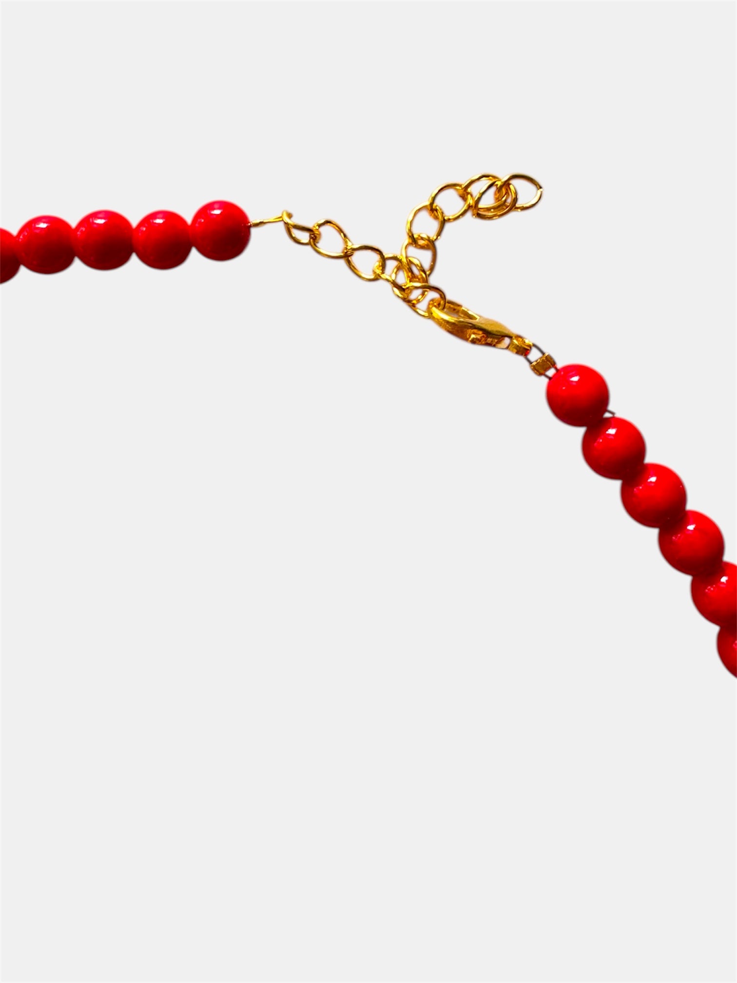 Red necklace featuring turquoise teardrop-shaped pendants for a vibrant and stylish look
