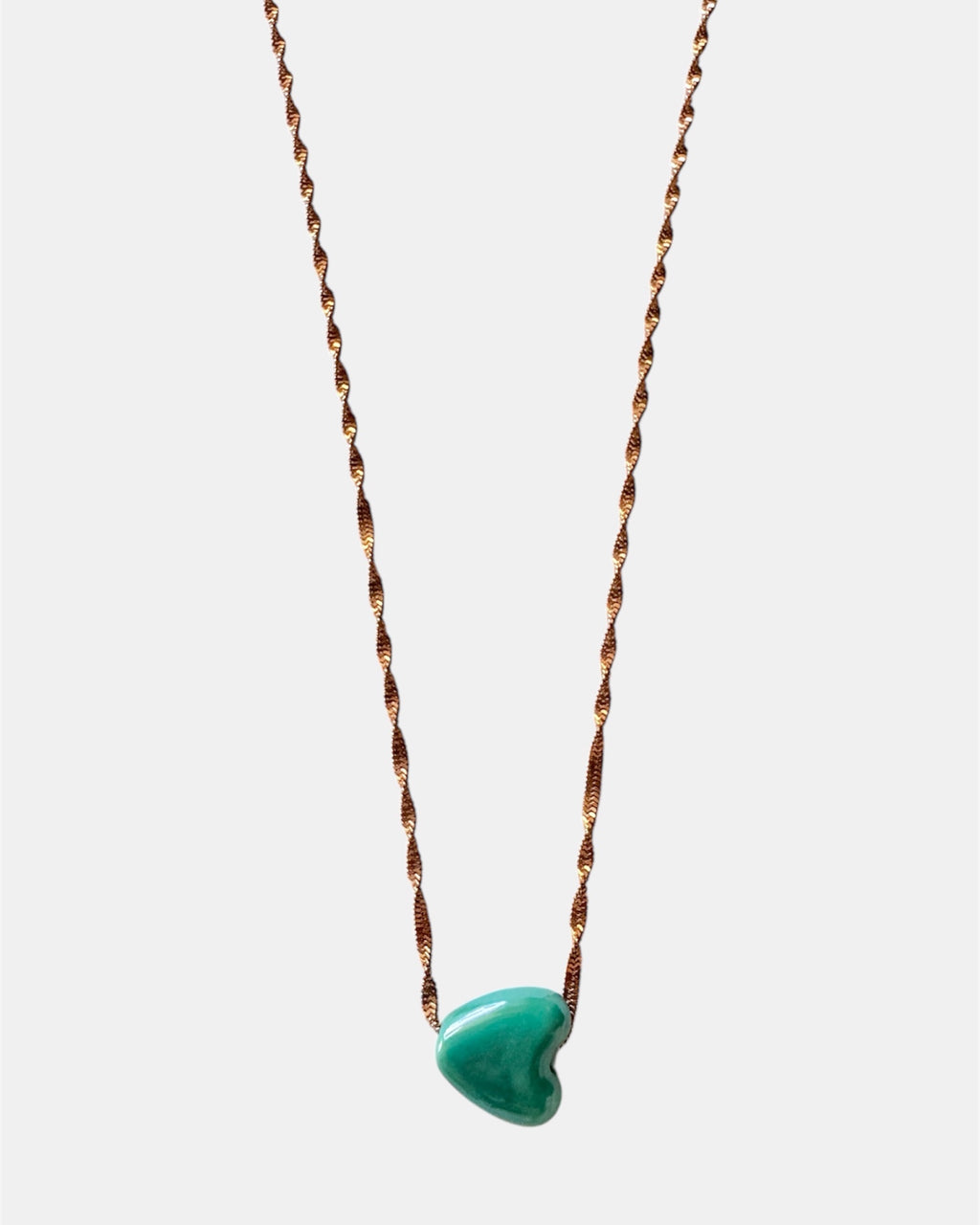 Rose gold chain necklace with a green heart charm